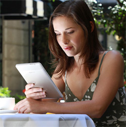 promotional photograph of a young woman with a Kindle device
