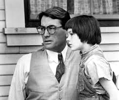 Gregory Peck with young actress Mary Badham on his knee